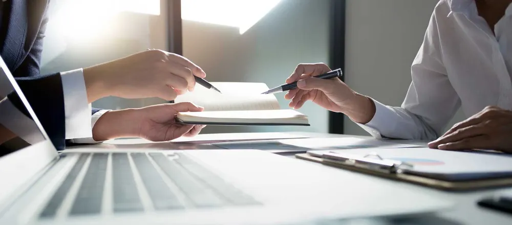 A business owner working through plans with a business consultant